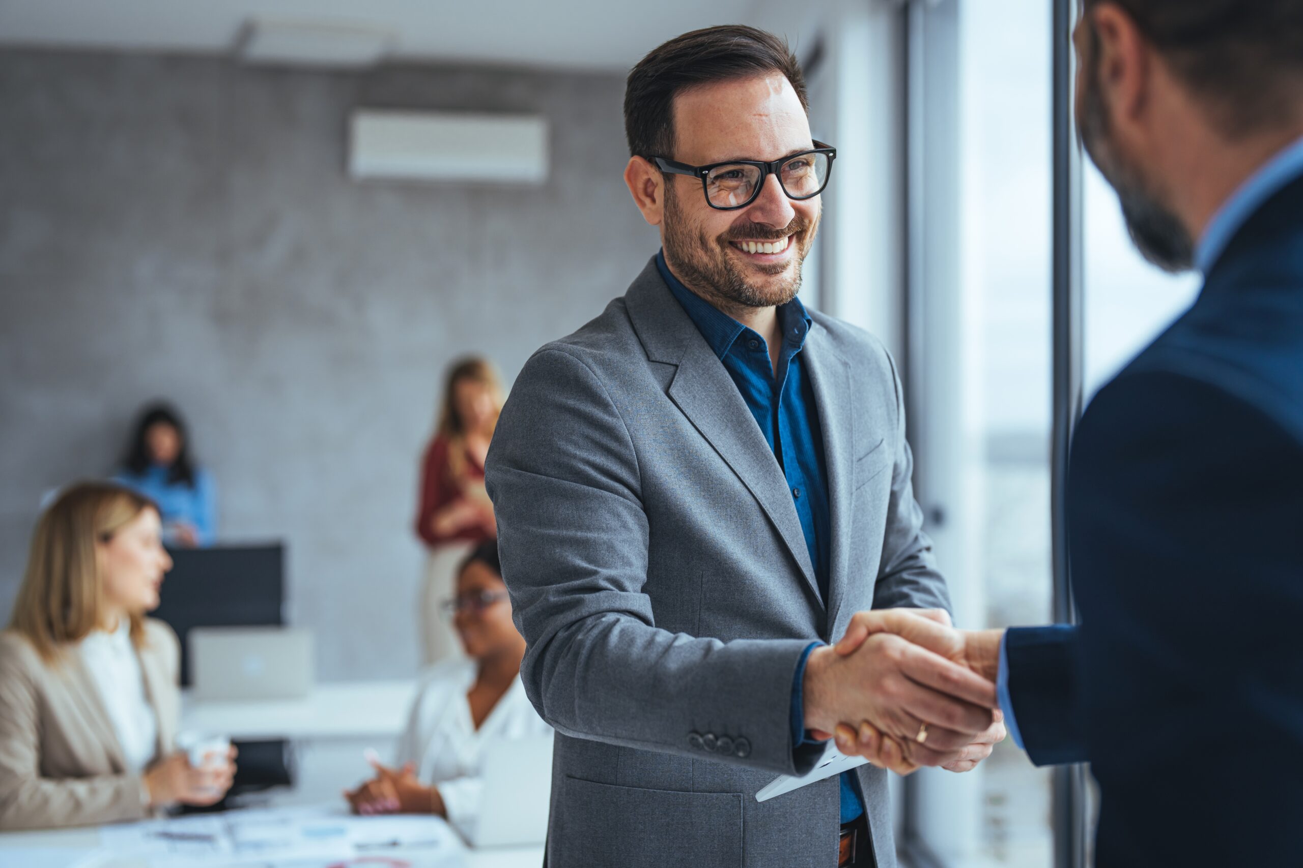 Shot,Of,Two,Businessmen,Shaking,Hands,In,An,Office.,Two